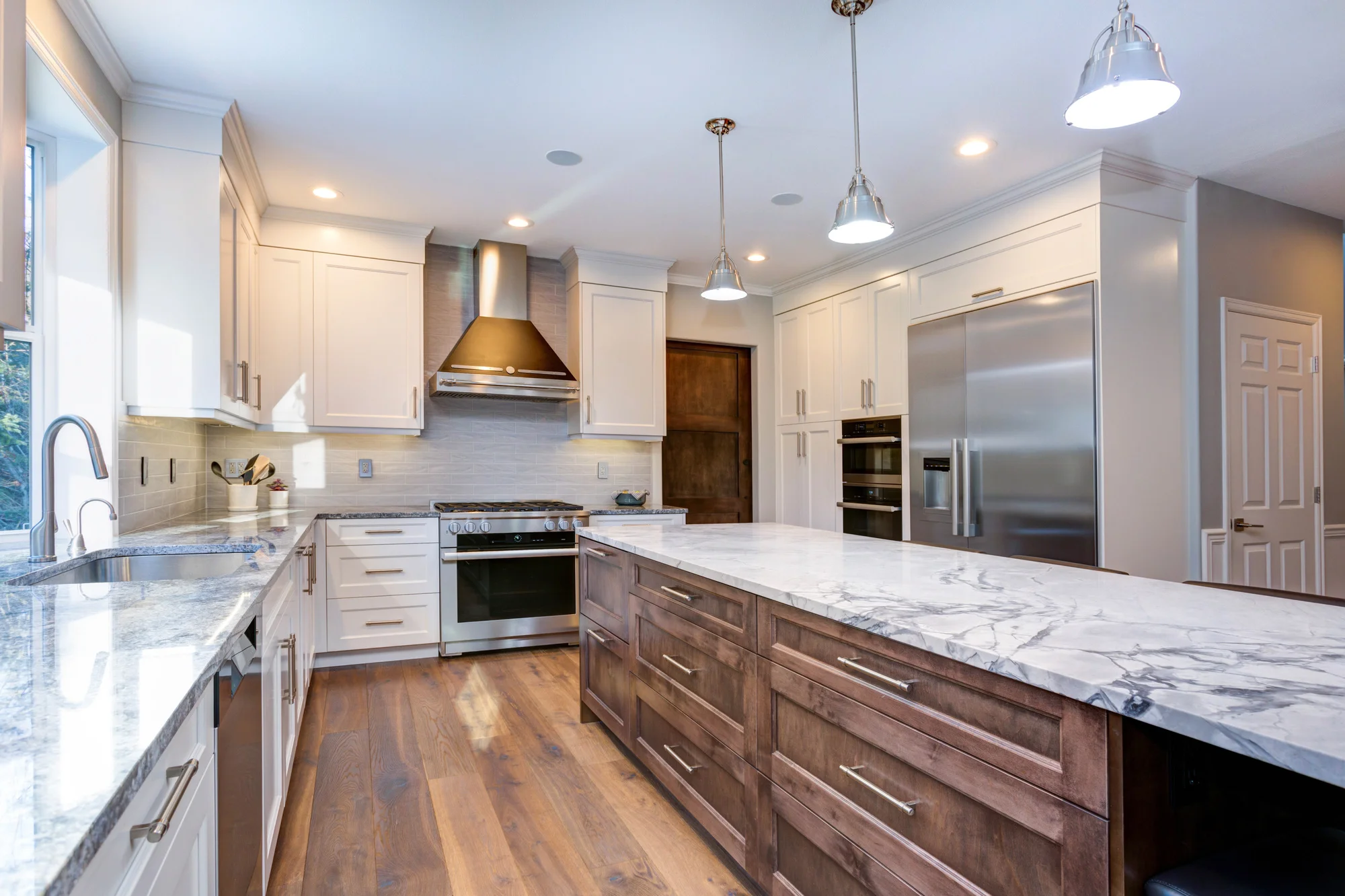 Beautiful kitchen remodel with white cabinets and marble countertops