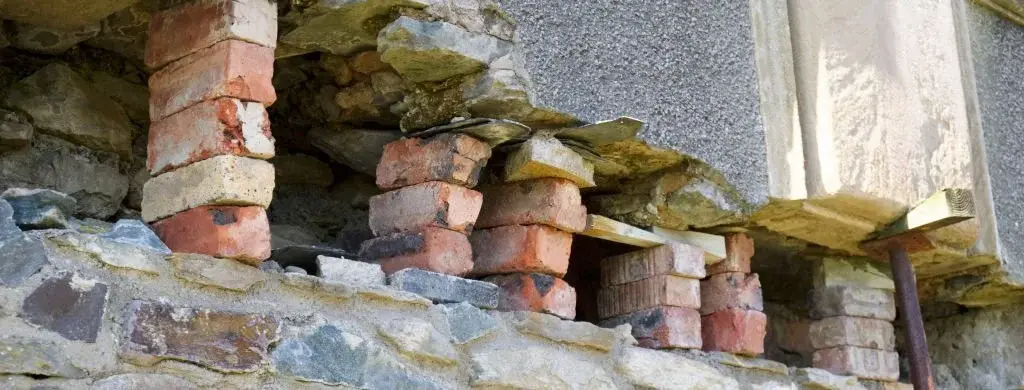 Structural support system for load bearing wall removal showing proper bracing and construction techniques